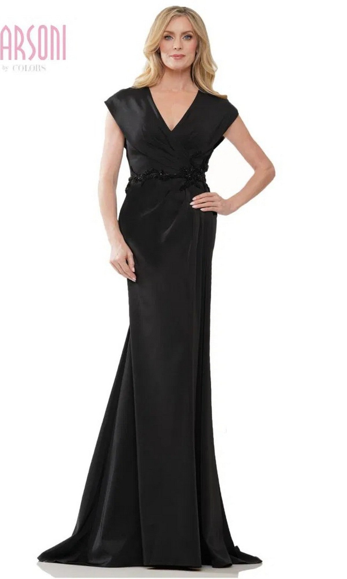 A woman wears the Marsoni MV1226 long formal dress in black, featuring a floor-length sheath silhouette, cap sleeves, V-neckline, and floral detailing at the waist.